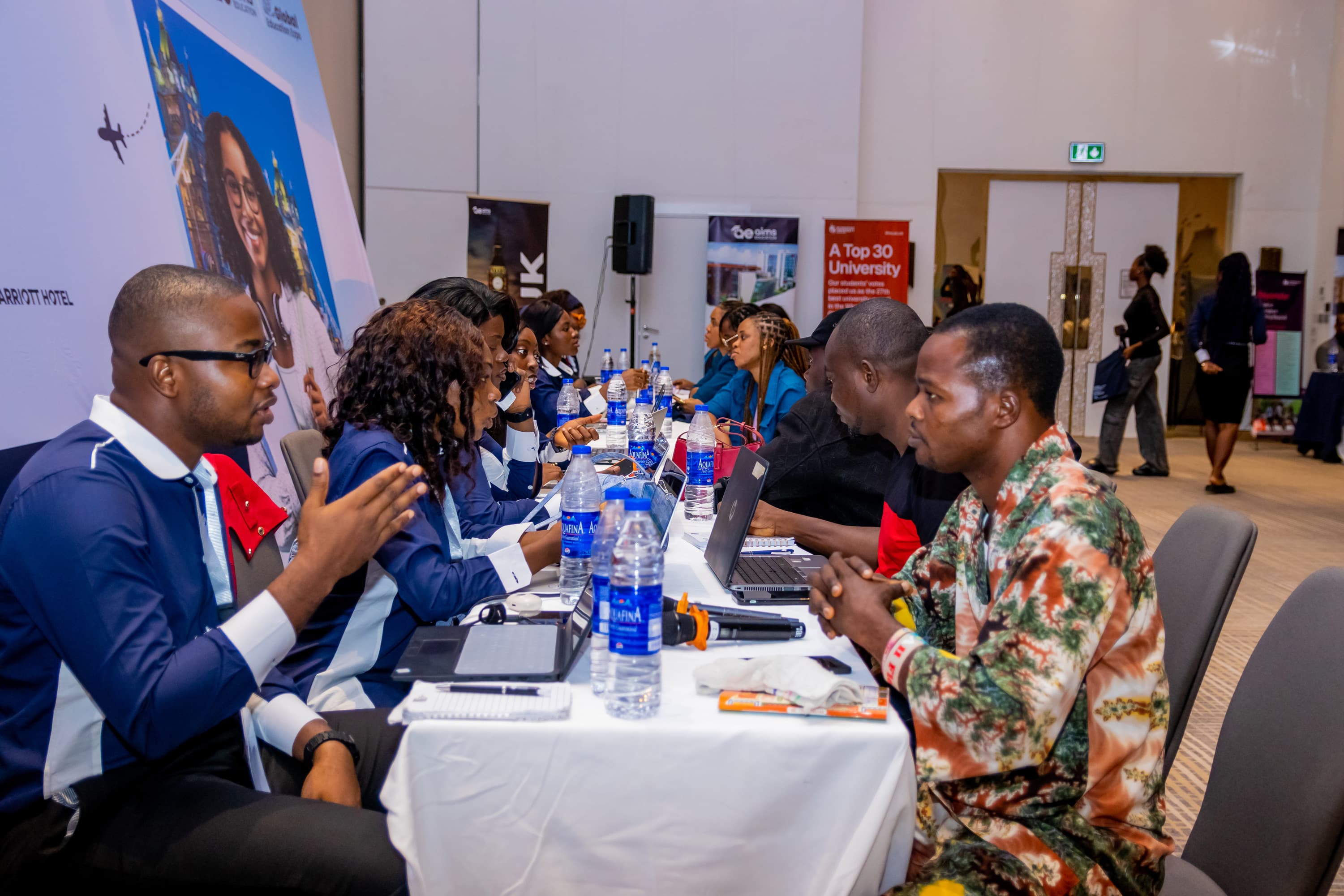 Students meeting university representatives at an Aims Education study abroad event